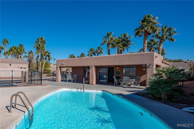 pool featuring a patio and fence