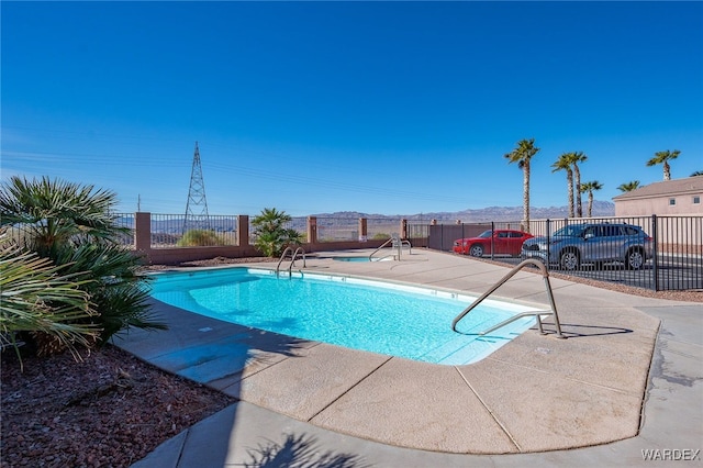 community pool featuring a patio area and fence