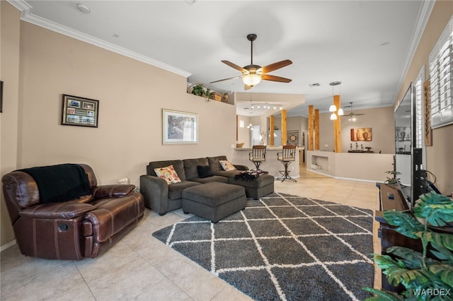 living area with crown molding, light tile patterned floors, visible vents, a ceiling fan, and baseboards