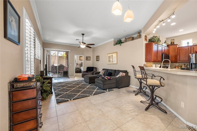 living area with light tile patterned floors, plenty of natural light, and crown molding