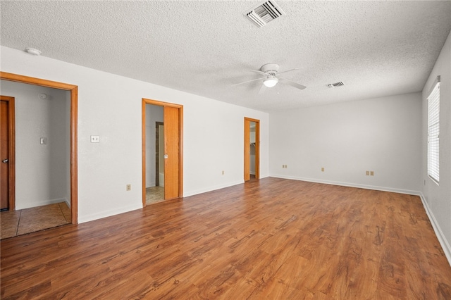 2218 Family Cir, Bullhead City, AZ 86442 - spare room with ceiling fan, wood finished floors, a textured ceiling, and a smoke detector