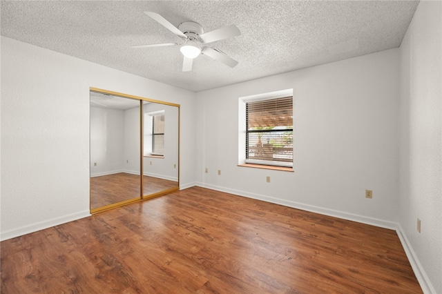 2218 Family Cir, Bullhead City, AZ 86442 - unfurnished bedroom with wood finished floors, a textured ceiling, a closet, and ceiling fan