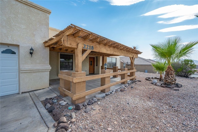2218 Family Cir, Bullhead City, AZ 86442 - rear view of property with stucco siding and a pergola