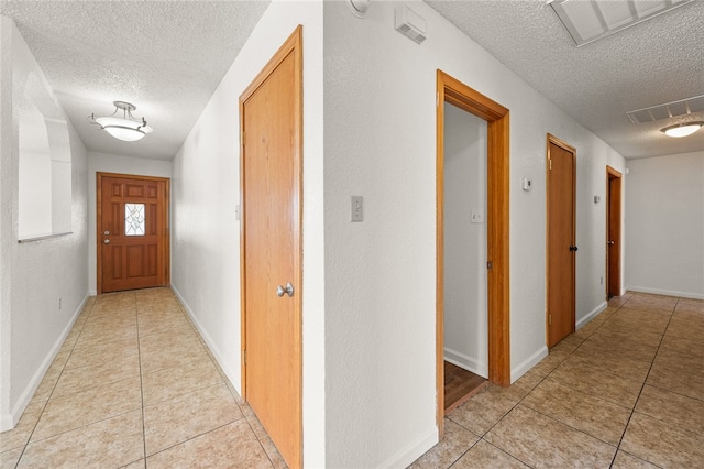 2218 Family Cir, Bullhead City, AZ 86442 - hallway with a textured ceiling and light tile patterned flooring