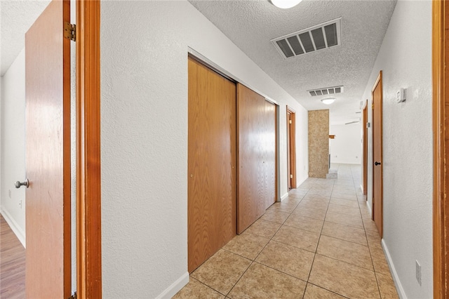 2218 Family Cir, Bullhead City, AZ 86442 - hall featuring a textured ceiling, light tile patterned floors, and a textured wall