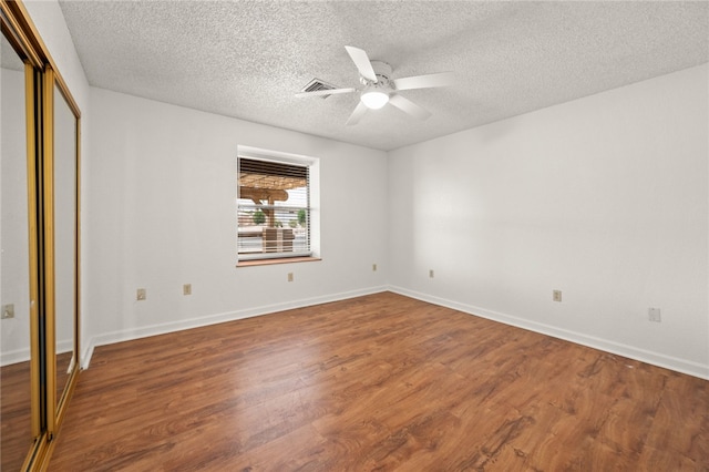 2218 Family Cir, Bullhead City, AZ 86442 - unfurnished bedroom with wood finished floors, a textured ceiling, a ceiling fan, and a closet