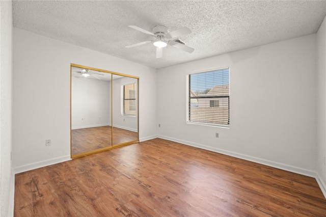 2218 Family Cir, Bullhead City, AZ 86442 - unfurnished bedroom with wood finished floors, a textured ceiling, a closet, and ceiling fan