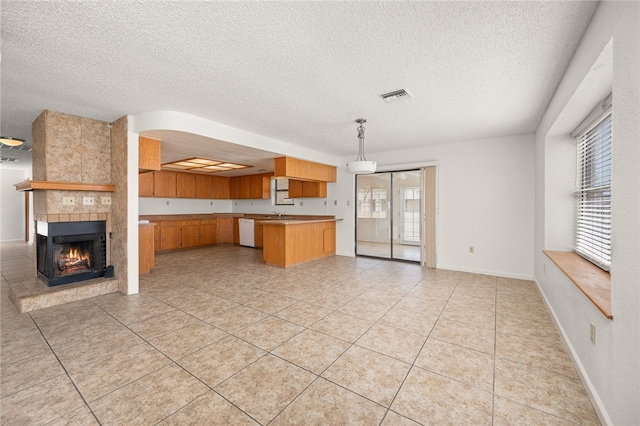 2218 Family Cir, Bullhead City, AZ 86442 - kitchen featuring open floor plan, dishwasher, a textured ceiling, and healthy amount of natural light