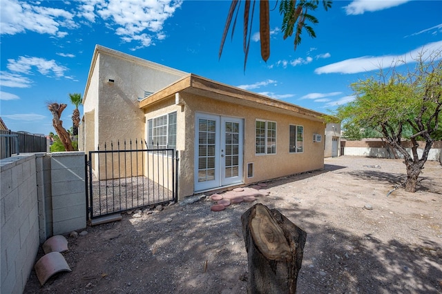 2218 Family Cir, Bullhead City, AZ 86442 - rear view of house with stucco siding, a fenced backyard, french doors, and a patio area