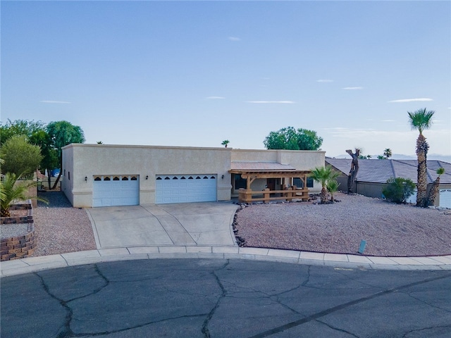 2218 Family Cir, Bullhead City, AZ 86442 - view of front facade with a garage, driveway, and stucco siding