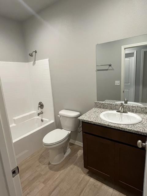 3521 E Lum Ave, Kingman, AZ 86409 - bathroom with wood finished floors, toilet, vanity, washtub / shower combination, and baseboards