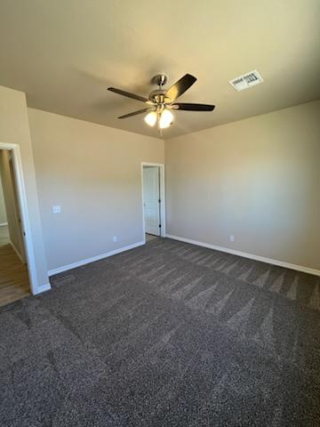 3521 E Lum Ave, Kingman, AZ 86409 - empty room featuring dark carpet and baseboards