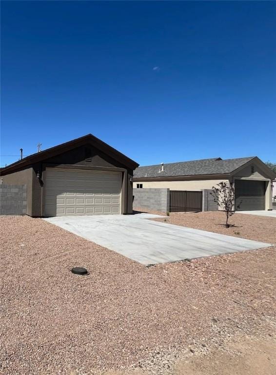 3521 E Lum Ave, Kingman, AZ 86409 - view of front of home featuring fence, driveway, and an attached garage