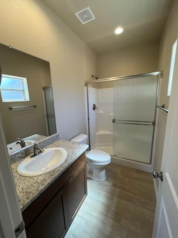 3521 E Lum Ave, Kingman, AZ 86409 - bathroom with a shower stall, vanity, wood finished floors, and recessed lighting