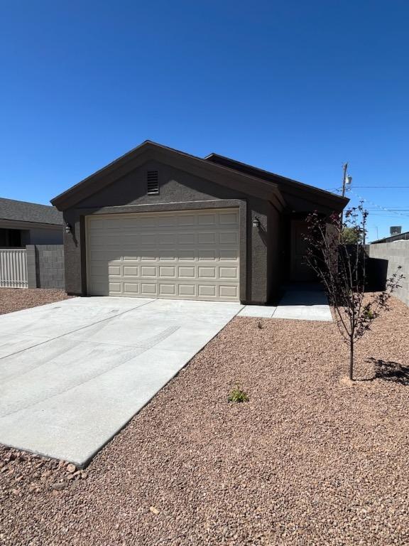 3521 E Lum Ave, Kingman, AZ 86409 - single story home with driveway, a garage, and fence