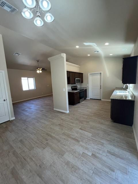3521 E Lum Ave, Kingman, AZ 86409 - unfurnished living room with baseboards, a sink, a ceiling fan, light wood finished floors, and recessed lighting
