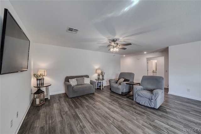 interior space with baseboards, visible vents, dark wood finished floors, and a ceiling fan