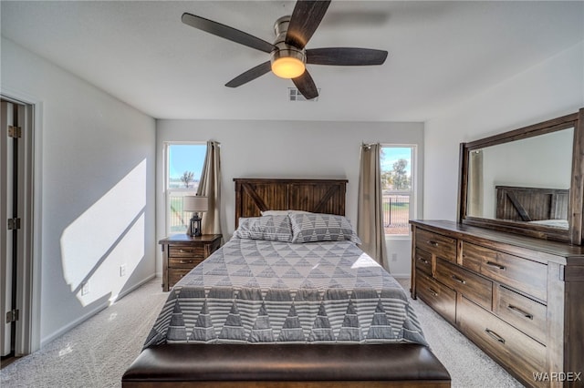 bedroom featuring visible vents, ceiling fan, light carpet, and baseboards