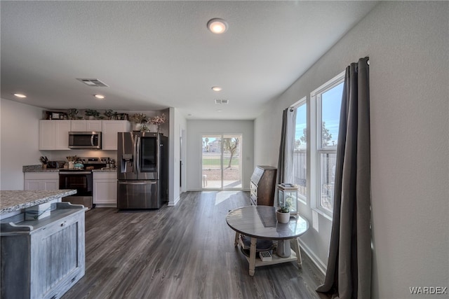 kitchen with white cabinets, visible vents, stainless steel appliances, and light countertops