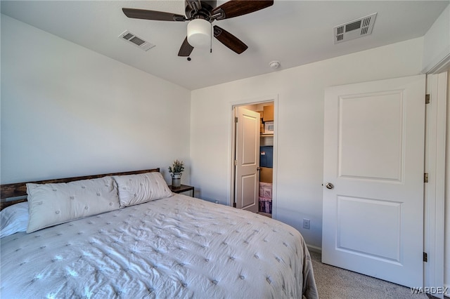 bedroom featuring ceiling fan, visible vents, and light colored carpet