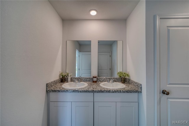 bathroom with double vanity and a sink