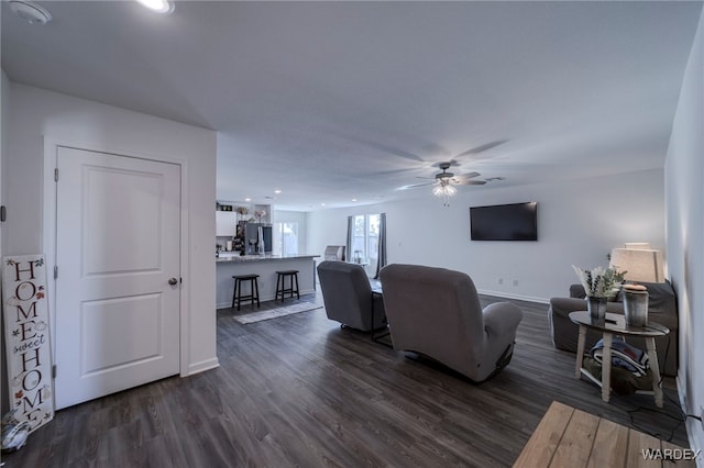 living area featuring recessed lighting, dark wood finished floors, a ceiling fan, and baseboards