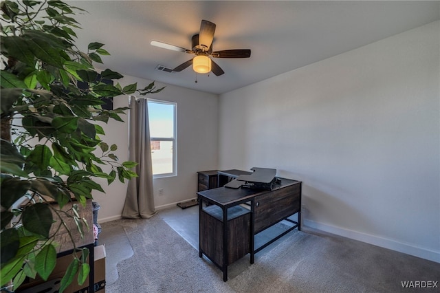 office space featuring a ceiling fan, visible vents, and baseboards