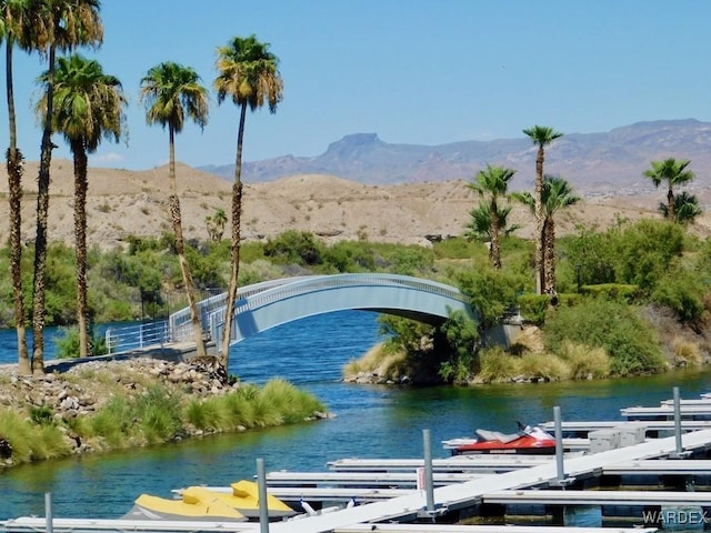 view of water feature with a dock and a mountain view