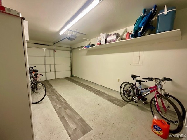 garage with bike storage and a garage door opener