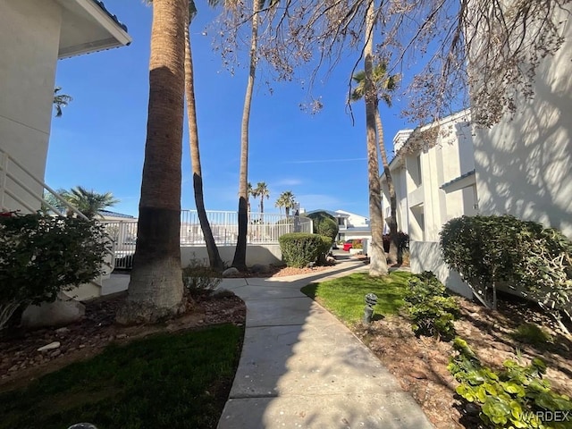 view of home's community featuring fence