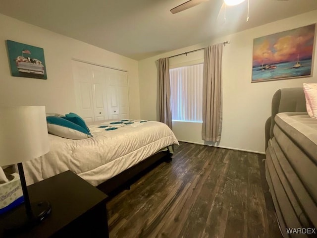 bedroom with ceiling fan, dark wood-type flooring, and a closet