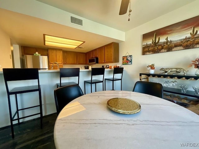 dining room with visible vents and a ceiling fan