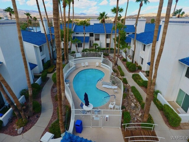 view of swimming pool featuring a residential view and fence