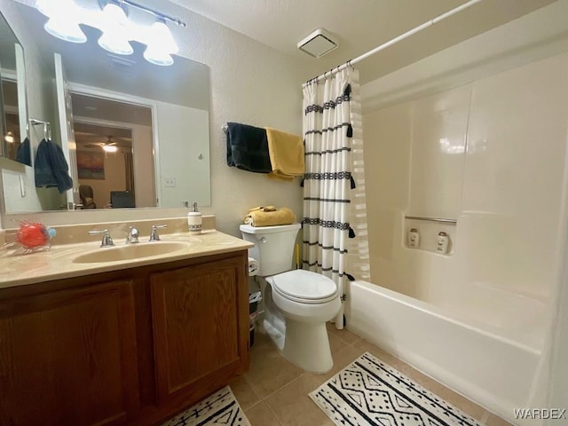 bathroom featuring toilet, shower / bath combo, ceiling fan, vanity, and tile patterned floors