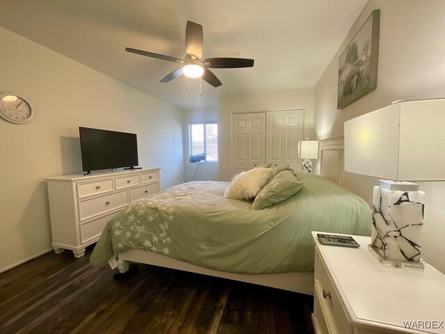 bedroom with dark wood-type flooring, a closet, and a ceiling fan