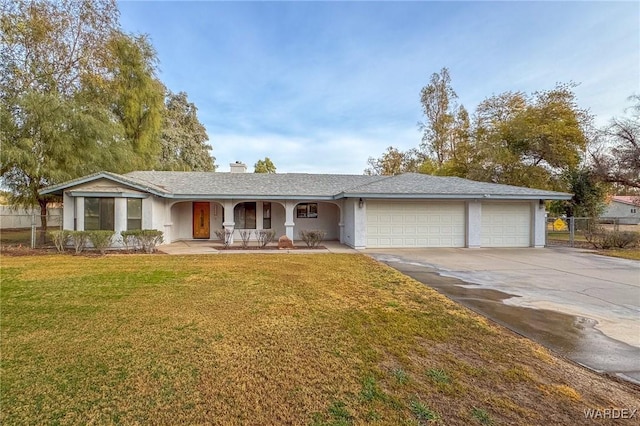 ranch-style home with a garage, concrete driveway, covered porch, a front yard, and stucco siding