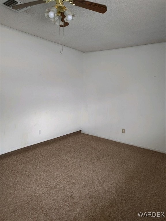 empty room with carpet floors, ceiling fan, and a textured ceiling