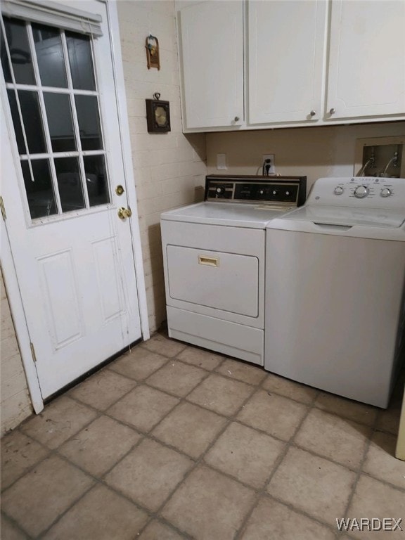 clothes washing area with cabinet space and independent washer and dryer