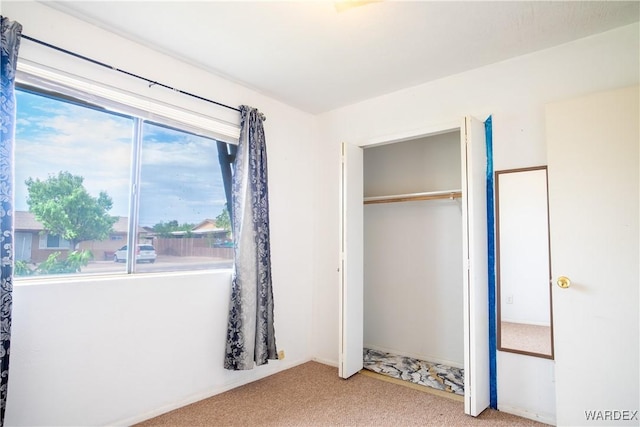 unfurnished bedroom featuring a closet and carpet flooring