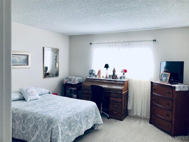 bedroom with light colored carpet and a textured ceiling