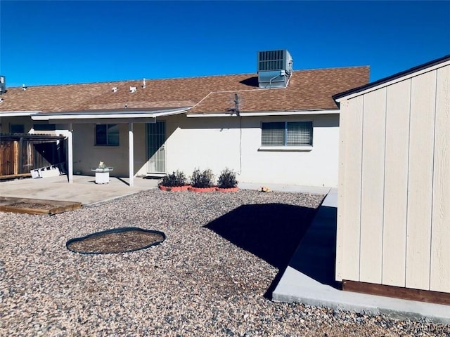 back of house featuring a patio area, fence, central AC, and roof with shingles