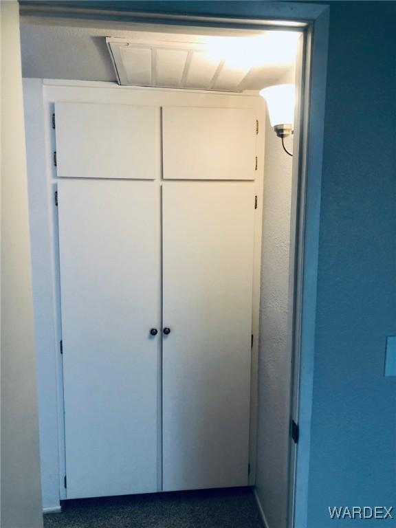 bedroom featuring a closet, light carpet, and a textured ceiling