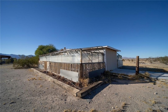 view of property exterior with a mountain view