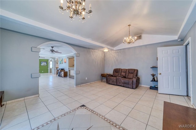 unfurnished living room with arched walkways, a notable chandelier, lofted ceiling, and light tile patterned floors