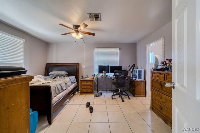 bedroom with visible vents, ceiling fan, and light tile patterned floors