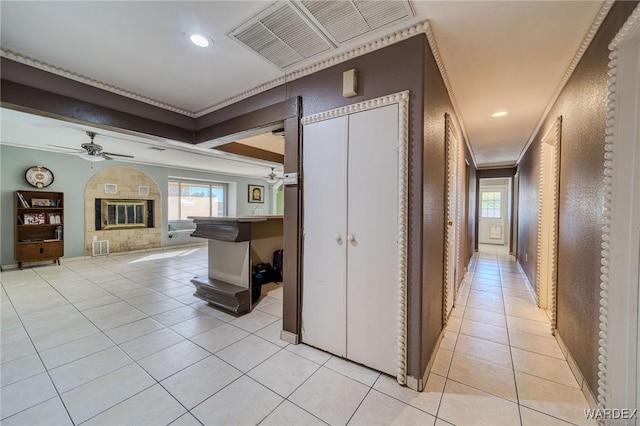 corridor featuring ornamental molding, recessed lighting, visible vents, and light tile patterned floors