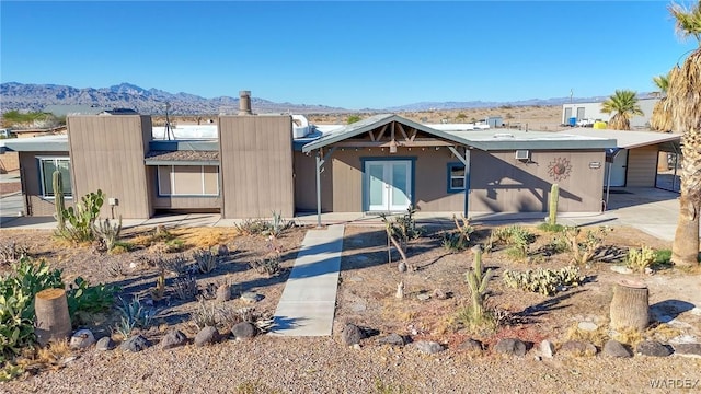 view of front of property with french doors and a mountain view