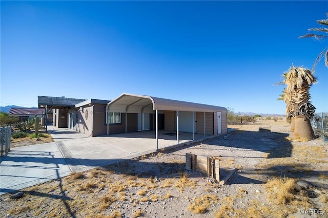 view of front facade featuring a carport and concrete driveway