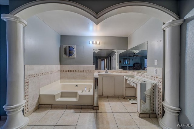 bathroom with a bath, vanity, decorative columns, and tile patterned floors