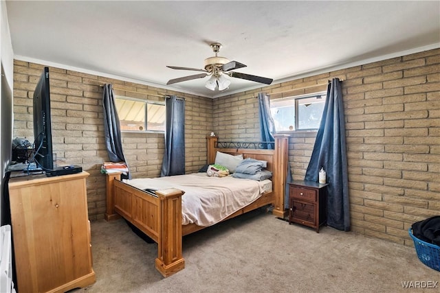 bedroom with brick wall, carpet, and a ceiling fan